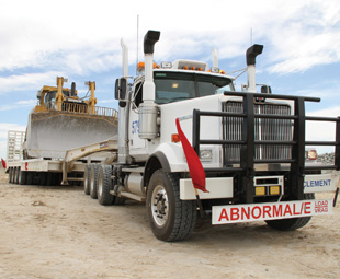 Mighty mover... a typical abnormal load rig delivering an earth-mover.