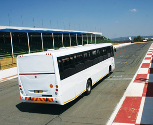 Race tracks are not foreign ground to me, but the idea of your average commuter bus racing around one of the country’s most well-known tracks (complete with full contingent of passengers) – well, that’s new territory. Who would be brave enough to do that?  Mercedes-Benz, obviously. And why not? Being the world leader in bus chassis production has to count for something. The company was keen to show this off at its very first bus and coach track day held in mid-September at Kyalami Race Track in Midrand, Gauteng.  All Mercedes-Benz commuter bus chassis are imported from Brazil, and we’re not talking about buses based on truck chassis. These are dedicated bus chassis – and driving around the track, it showed.  Guests were given the opportunity to sample four vehicles built on Mercedes-Benz chassis OF 1726 and OF 1730, fitted with 194 kW (260 hp) and 224 kW (300 hp) engines respectively. Two were fitted with Marcopolo bodies, one by MCV and one wearing a Busco Predator body. “Climb in; we’re going for a ride!” Not your everyday invitation, and not your everyday bus ride. With a member of the Mercedes-Benz Dynamic Driving team behind wheel, we were able to witness and experience the impressive road-holding, minimal lean angles, overall stability and impressive braking systems of the buses as they went through a slalom and around the rather technical track. Guests were also able to sample the buses’ ease of maneuverability by competing in a parking exercise and were able to put their mechanicals to the test with a series of drag races. But it wasn’t all fun and games – representatives from every area of Mercedes-Benz’s bus and coach business were on hand to provide facts and figures.  “After the World Cup, we expected the market to collapse,” says Mercedes-Benz South Africa vice president of Commercial Vehicles, Kobus van Zyl. “But we then focused on customers requiring replacements with ready-built buses.”  Sold through a dedicated bus dealer network, all aspects of the Mercedes-Benz value chain are offered to heighten the customer experience. From finance (Mercedes-Benz Financial Services has financed over 2 000 buses since 1997) and the company’s CharterWay warranty offerings, to genuine parts, after-sales service excellence and even buying from or selling into the second-hand market via the newly launched TruckStore (see page 40), all needs are taken care of. Mercedes-Benz Bus and Coach Brand Manager Dirk Ansorge concluded by saying, “It is indeed our strength as MBSA that we can offer product and value chain services to customers through our strong dealer network. We are all committed to sustainable partnerships.” 