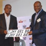 HOD Bailey Mahlakoleng (left) hands over a set of securitised number plates to MEC Gaoage Molapisi of the Bokone Bophirima Department of Community Safety and Transport Management.